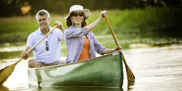 active adult couple in canoe